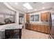 Bright kitchen featuring a skylight, stainless steel appliances, and oak cabinetry at 2951 W Plum Hollow Dr, Anthem, AZ 85086