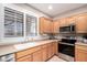 The kitchen offers stainless steel appliances, neutral countertops, and an abundance of cabinetry at 2951 W Plum Hollow Dr, Anthem, AZ 85086
