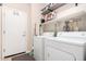 Functional laundry room with modern washer and dryer, shelving, and storage options for added convenience at 2951 W Plum Hollow Dr, Anthem, AZ 85086