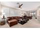 Inviting living room with a leather sectional, a ceiling fan, and natural light at 2951 W Plum Hollow Dr, Anthem, AZ 85086