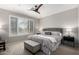 Serene main bedroom featuring a ceiling fan, neutral colors, and a large window at 2951 W Plum Hollow Dr, Anthem, AZ 85086