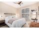 Well-lit bedroom with a large window, fan, and a cozy, inviting atmosphere at 2951 W Plum Hollow Dr, Anthem, AZ 85086