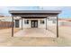 A covered backyard patio great for outdoor dining and gatherings, conveniently accessible through black double doors at 3217 E Friess Dr, Phoenix, AZ 85032