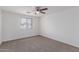 Bedroom with a ceiling fan, carpet flooring and window for natural lighting at 3217 E Friess Dr, Phoenix, AZ 85032