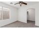 This bedroom offers cozy carpet flooring, a ceiling fan, and great natural light at 3217 E Friess Dr, Phoenix, AZ 85032
