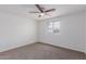 Bedroom has a bright window with neutral carpet and white walls at 3217 E Friess Dr, Phoenix, AZ 85032