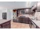 Updated kitchen with stainless steel appliances and dark wood cabinetry for modern style at 3217 E Friess Dr, Phoenix, AZ 85032