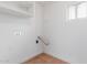 Laundry room has hookups, shelves, and neutral tile at 3217 E Friess Dr, Phoenix, AZ 85032
