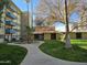 Beautiful courtyard featuring a lush green lawn, mature trees, and a walkway at 349 E Thomas Rd # E402, Phoenix, AZ 85012