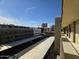 View from balcony of the parking area, trees and neighborhood buildings at 349 E Thomas Rd # E402, Phoenix, AZ 85012