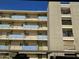 Apartment complex featuring several units with balconies and covered parking below at 349 E Thomas Rd # E402, Phoenix, AZ 85012