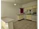 A bright kitchen with tiled floor, white appliances and yellow cabinets at 349 E Thomas Rd # E402, Phoenix, AZ 85012