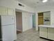 A bright kitchen with tiled floor, white appliances and yellow cabinets at 349 E Thomas Rd # E402, Phoenix, AZ 85012