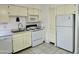 A bright kitchen with tiled floor, white appliances and yellow cabinets at 349 E Thomas Rd # E402, Phoenix, AZ 85012