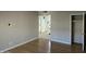 Empty living room with hardwood floors, neutral paint and a view of a bathroom and kitchen at 349 E Thomas Rd # E402, Phoenix, AZ 85012