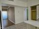 View of the living room and kitchen area, featuring tiled and hardwood floors at 349 E Thomas Rd # E402, Phoenix, AZ 85012