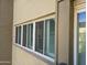 Exterior view of the building featuring windows with wood shutters, and a exterior column at 349 E Thomas Rd # E402, Phoenix, AZ 85012