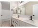 Bathroom vanity with double sinks, white cabinets, black fixtures, and large mirror at 4129 E Nighthawk Way, Phoenix, AZ 85048