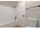 Bathroom featuring a shower-tub combo, toilet, towel bar, and neutral-toned walls at 4129 E Nighthawk Way, Phoenix, AZ 85048