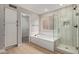 Bright bathroom with a glass enclosed shower and a luxurious tub at 4129 E Nighthawk Way, Phoenix, AZ 85048