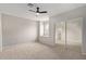 Bedroom featuring a ceiling fan, a sliding door closet, and neutral-toned walls and carpet at 4129 E Nighthawk Way, Phoenix, AZ 85048
