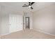 This bedroom offers closet space, a ceiling fan, and neutral-toned walls and carpet at 4129 E Nighthawk Way, Phoenix, AZ 85048