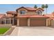 This property features a spacious three-car garage and desert-style landscaping at 4129 E Nighthawk Way, Phoenix, AZ 85048