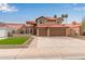 Two-story home featuring a red tile roof, desert landscaping, and an attached three-car garage at 4129 E Nighthawk Way, Phoenix, AZ 85048