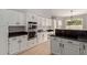 Well-lit kitchen features stainless steel double oven, granite counters, and white cabinets at 4129 E Nighthawk Way, Phoenix, AZ 85048
