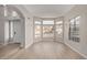 Sun-drenched open concept living space with wood floors, a arched doorway, and multiple windows at 4129 E Nighthawk Way, Phoenix, AZ 85048