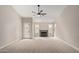 A well-lit living room featuring a fireplace, ceiling fan and access to the back yard at 4129 E Nighthawk Way, Phoenix, AZ 85048