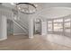 Open living room featuring wood floors, an arched entrance, and a staircase at 4129 E Nighthawk Way, Phoenix, AZ 85048