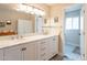 Bathroom featuring a double vanity with marble countertop, white cabinetry, and modern fixtures at 4325 E Sacaton St, Phoenix, AZ 85044