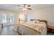 Comfortable bedroom with wood-look tile flooring, French doors, and a view of the outdoor space at 4325 E Sacaton St, Phoenix, AZ 85044
