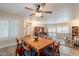 Dining Room with wooden table and chairs under a ceiling fan with light wood flooring at 4325 E Sacaton St, Phoenix, AZ 85044