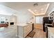 Bright, modern kitchen features white cabinetry, stainless steel appliances, and a large island with seating at 4325 E Sacaton St, Phoenix, AZ 85044