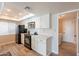Modern kitchen with white cabinets, black appliances, and an adjacent laundry area at 4325 E Sacaton St, Phoenix, AZ 85044