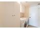 Bright laundry room with storage cabinets above the washer and dryer, and a utility closet at 4325 E Sacaton St, Phoenix, AZ 85044
