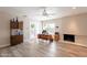 Spacious living room with a white brick fireplace, wood-look tile flooring, and ample natural light at 4325 E Sacaton St, Phoenix, AZ 85044