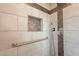 Modern walk-in shower with stylish tile work, a built-in niche, and a convenient hand-held shower head at 4325 E Sacaton St, Phoenix, AZ 85044
