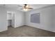 Bedroom featuring plush carpet, standard closet, and a large window at 43646 W Elizabeth Ave, Maricopa, AZ 85138