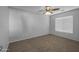 Bedroom with neutral carpet, ceiling fan, and a bright window at 43646 W Elizabeth Ave, Maricopa, AZ 85138