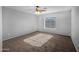 Bedroom with neutral carpet, ceiling fan, and a bright window at 43646 W Elizabeth Ave, Maricopa, AZ 85138