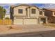 Inviting two-story home featuring a three-car garage and neutral stucco exterior at 43646 W Elizabeth Ave, Maricopa, AZ 85138