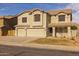 Inviting two-story home featuring a three-car garage and neutral stucco exterior at 43646 W Elizabeth Ave, Maricopa, AZ 85138