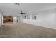 Open-concept living area with easy flow to the kitchen, modern ceiling fan, and light-filled windows at 43646 W Elizabeth Ave, Maricopa, AZ 85138