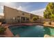 Beautiful backyard with a refreshing pool and a covered patio at 43646 W Elizabeth Ave, Maricopa, AZ 85138