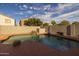Sparkling private pool with rock feature and privacy wall in the backyard at 43646 W Elizabeth Ave, Maricopa, AZ 85138