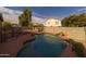 Beautiful backyard with a pool, rock waterfall and privacy wall at 43646 W Elizabeth Ave, Maricopa, AZ 85138