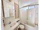 Well-lit bathroom with a vanity, toilet, cabinet and a shower-tub combination with curtain at 455 S Jaspar Dr, Apache Junction, AZ 85119